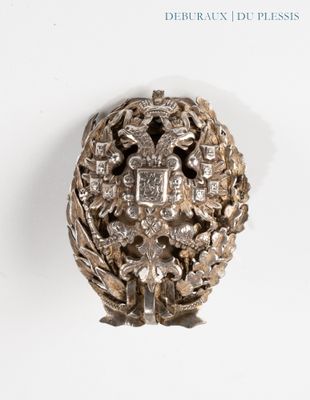 an image of a silver object on a white surface with a white background