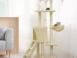 a cat sitting on a cat tree in a living room