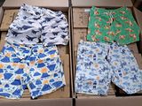 two boxes of men ' s swim trunks are sitting on a table