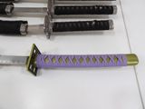 several different types of swords are lined up on a table