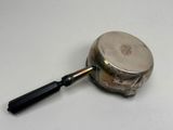 a magnifying glass with a black handle on a white surface