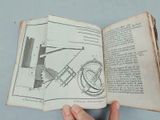 someone is holding an open book with a drawing of a plane on it