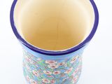a blue and white vase with a flower pattern on it