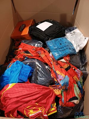 a cardboard box filled with clothing and a suitcase
