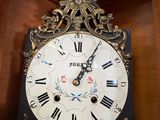 a clock that is hanging on the wall in the room