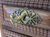 a close up of a wooden drawer with a brass handle