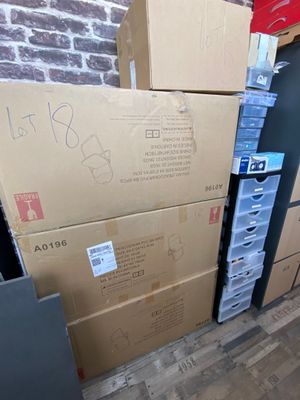 many boxes stacked on top of each other in a room