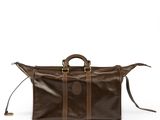 a brown leather duffel bag sitting on top of a white surface