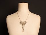 an image of a mannequin torso with a necklace on it