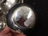 a person holding a silver object with a sticker on it