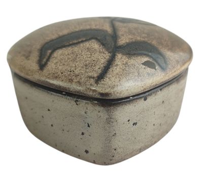 a brown and black box with a bird design on it