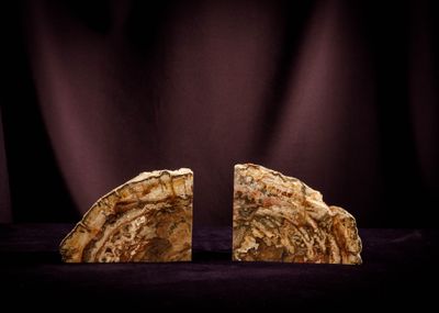 two pieces of rock are sitting side by side on a black background