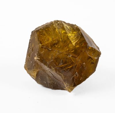 un gros plan d'un morceau de quartz jaune sur une surface blanche