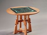 a wooden table with a green tile on top of it