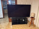 a flat screen tv sitting on a stand in a living room