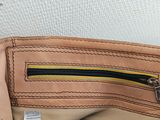 the inside of a tan purse with a zipper on it