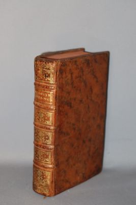 a book that is sitting on a table next to a clock