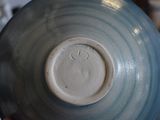 a close up of a blue and white bowl on a table