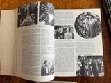 an open book with pictures of people on it on a table