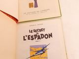 two books that are open on a white table