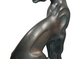 sculpture of a cat sitting on its hind legs on a white background