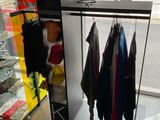 a man standing in front of a display of clothes