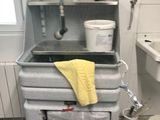 a dirty kitchen with a sink and a stove in it
