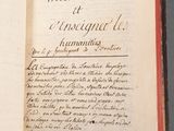 an open book with writing on it sitting on a table