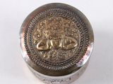 a silver box with a design on it on a white surface
