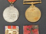 several medals and medals are displayed on a black surface