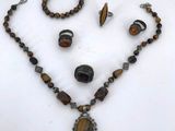 a necklace, bracelet, and ring set on a table