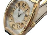 an image of a gold watch with a black leather strap
