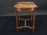 an image of a small table with a wooden top on a black background