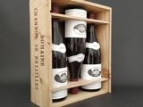 three bottles of wine in a wooden box