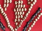 a close up of a red background with a bunch of beads on it