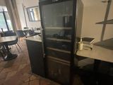 a refrigerator in the middle of a room with a table and chairs