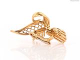 an image of a close up of a gold brooch with a bird on it