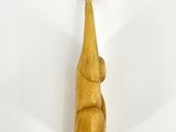 a wooden elephant figurine on a white surface