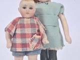 two dolls that are standing next to each other