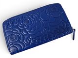 a close up of a blue purse on a white surface