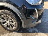 a close up of a car ' s front bumper with a denting on it