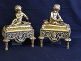 pair of antique brass figurines of a boy and a girl on a table