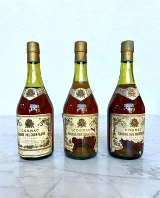 three bottles of wine sitting on a marble table