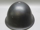 an old helmet is sitting on top of a white table