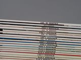 a lot of books that are stacked on top of each other