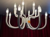 a white chandelier with many lights hanging from it