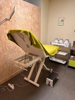 an image of a hospital room with a bed and a chair