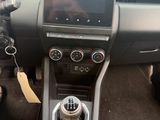 the interior of a car with a steering wheel and dashboard controls