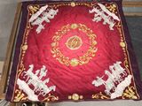 a table with a red table cloth with white animals on it