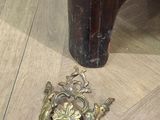 a small brass object on the floor next to a dresser